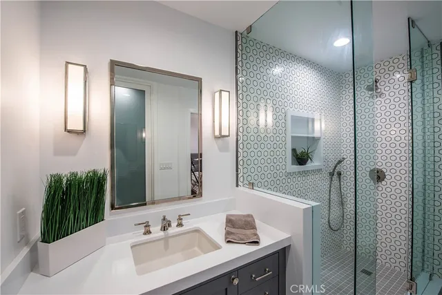 a bedroom with bed and a potted plant