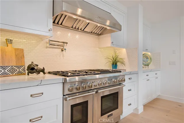 a white stove top oven sitting inside of a kitchen