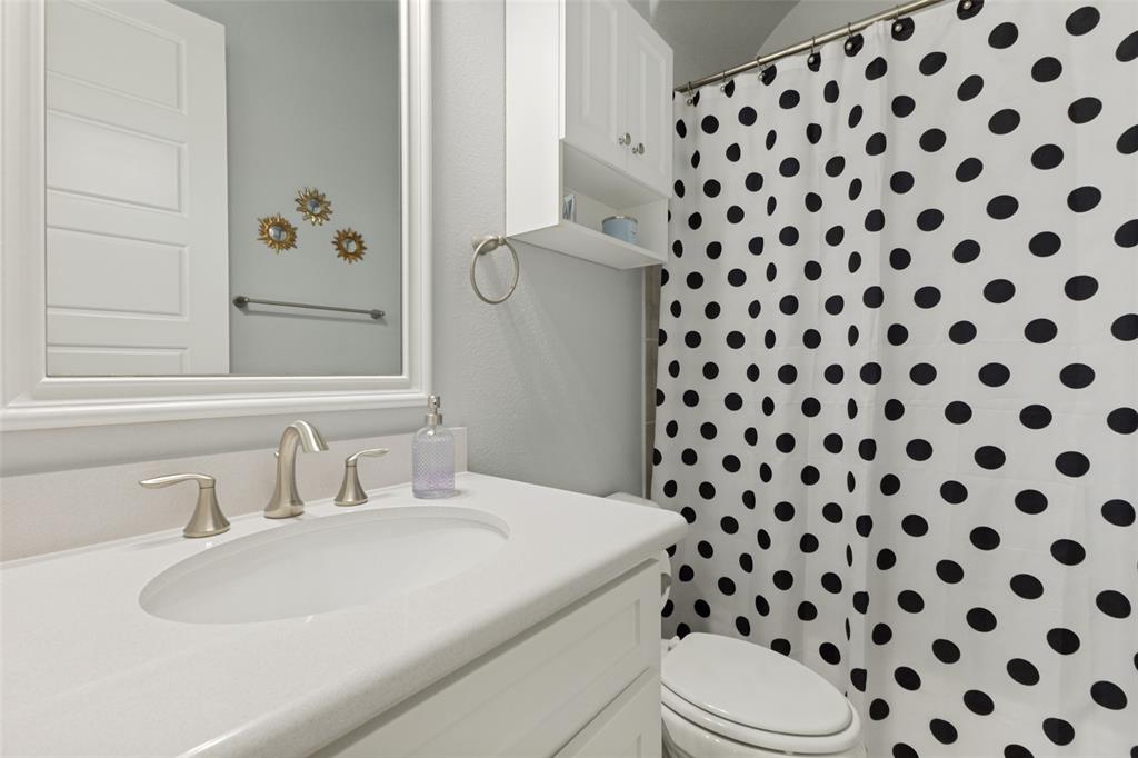 506 Life Spring Drive Rockwall, TX 75087 - Photo 25 of 36 a bathroom with a sink a toilet and a shower