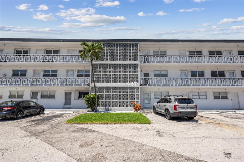 467 Golden Isles Drive, Unit 206 Hallandale Beach, FL 33009 - Photo 2 of 3 a car parked in front of a building