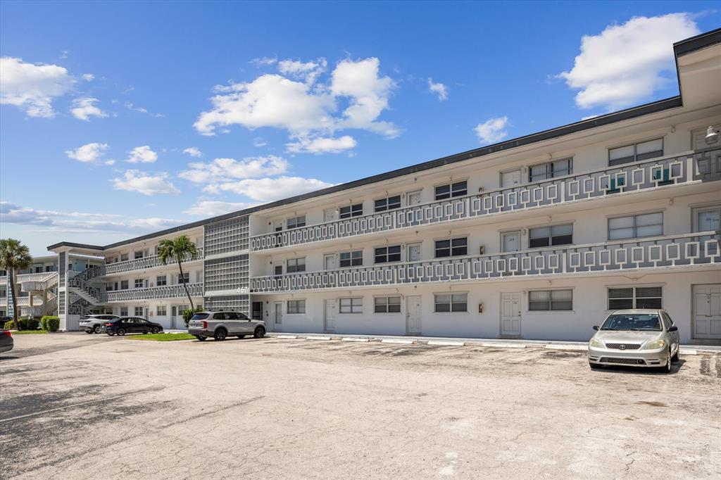467 Golden Isles Drive, Unit 206 Hallandale Beach, FL 33009 - Photo 3 of 3 a car parked in front of a building