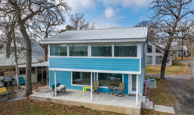 a view of a house with backyard porch and sitting area