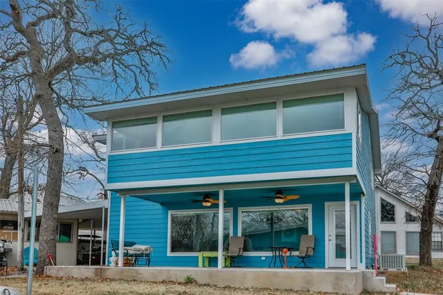 a living room with furniture and a view of kitchen