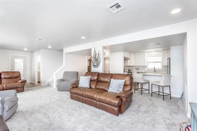 a kitchen with refrigerator cabinets and a sink