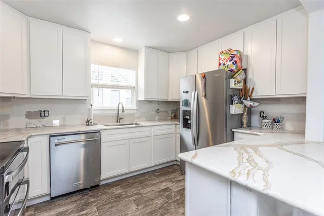 a kitchen with cabinets appliances and a counter space