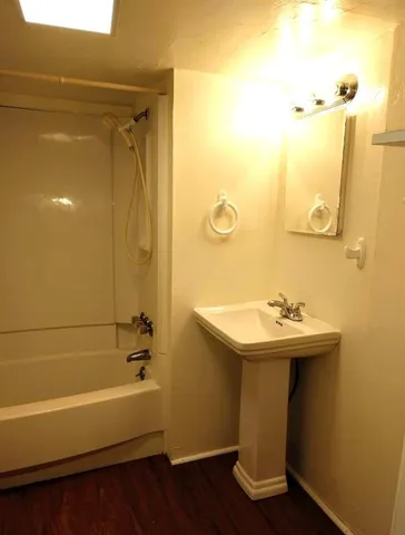 a bathroom with a sink a mirror and a bathtub