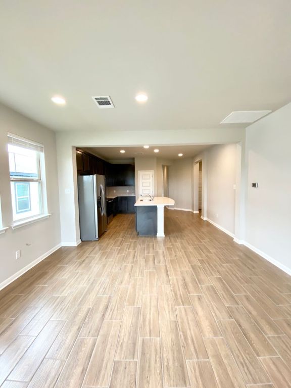 103 Wild Wind Cove Jarrell, TX 76537 - Photo 11 of 11 a view of empty room with wooden floor and window