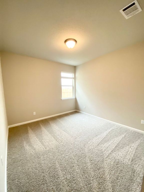 103 Wild Wind Cove Jarrell, TX 76537 - Photo 7 of 11 an empty room with windows