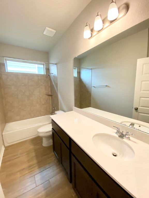 103 Wild Wind Cove Jarrell, TX 76537 - Photo 8 of 11 a bathroom with a sink double vanity granite tub shower and a mirror