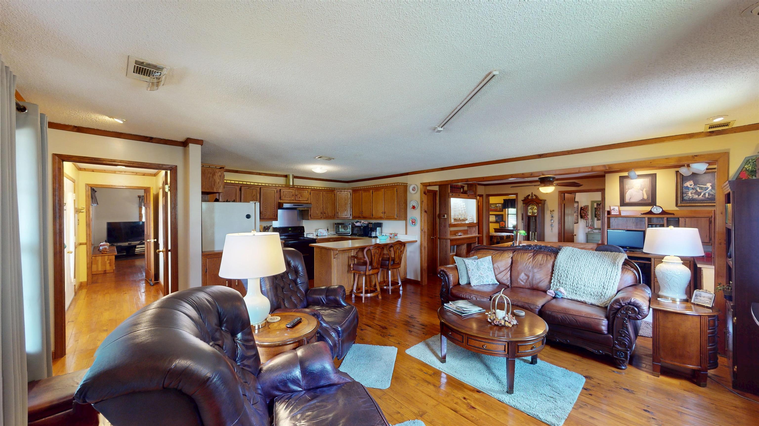 420 Joann Road Somerville, TN 38068 - Photo 6 of 40 Open-concept living area featuring wood-finish flooring, wood trim, and recessed lighting