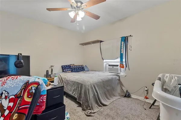 a bedroom with a bed and a chandelier