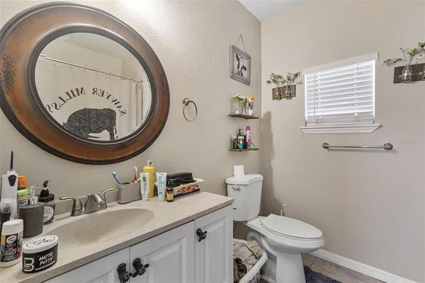 a bathroom with a toilet a sink and a mirror