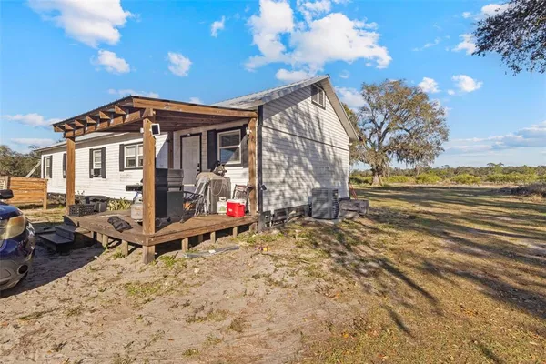 a view of a house with backyard and sitting area