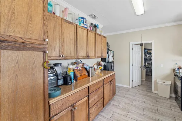 a view of a kitchen with fridge and workspace