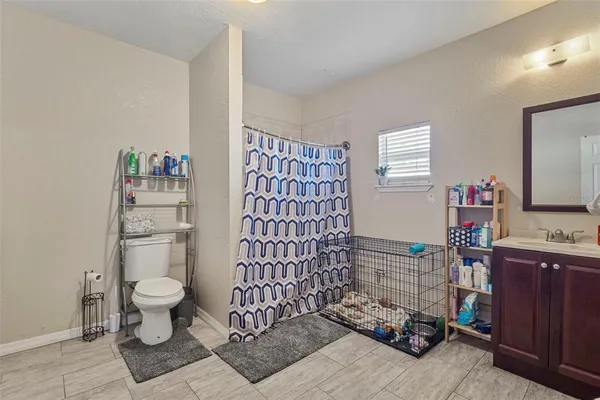 a bathroom with a sink toilet and shower