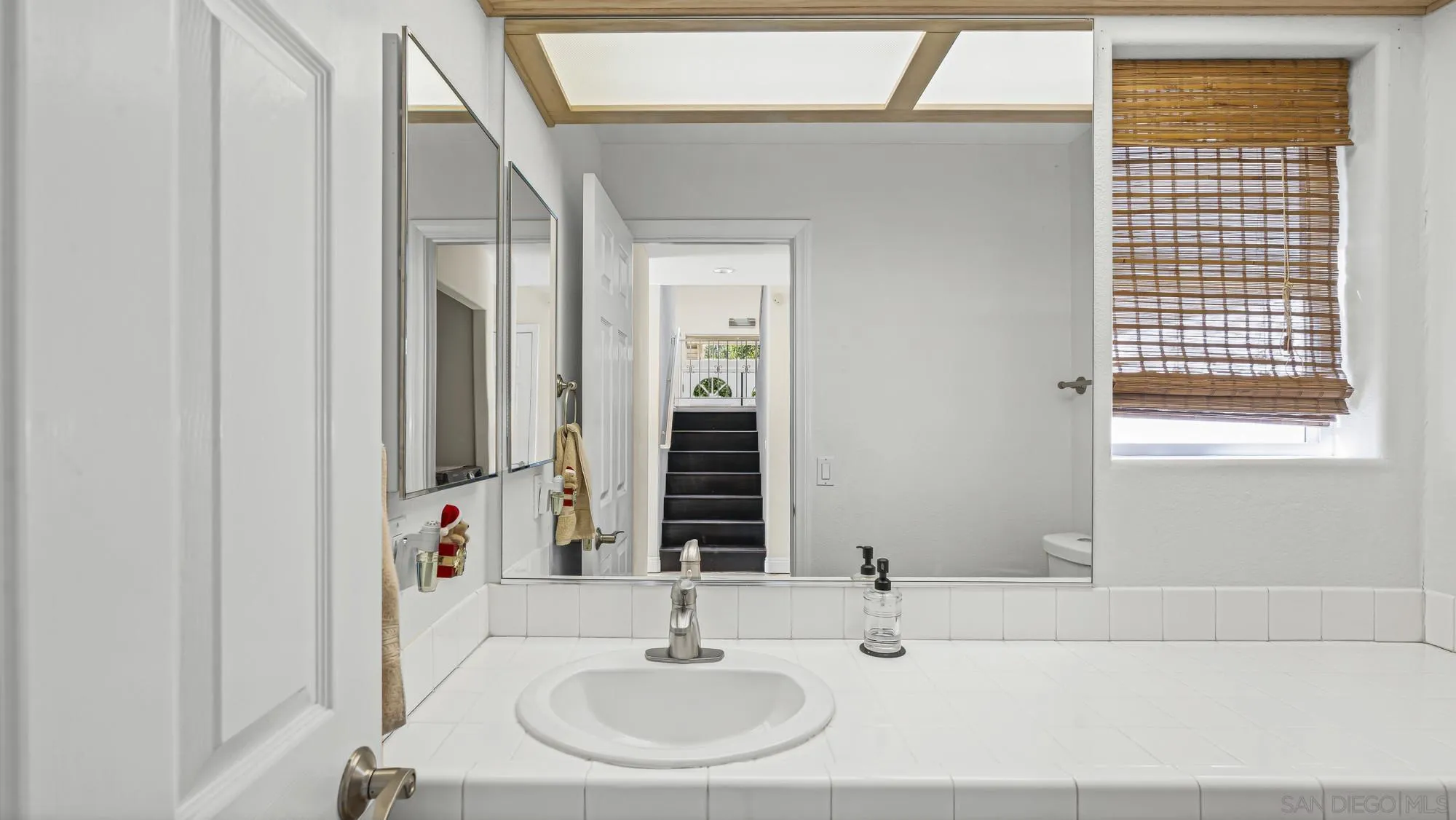 24249 Sargeant Road Ramona, CA 92065 - Photo 15 of 46 a bathroom with a sink and a mirror