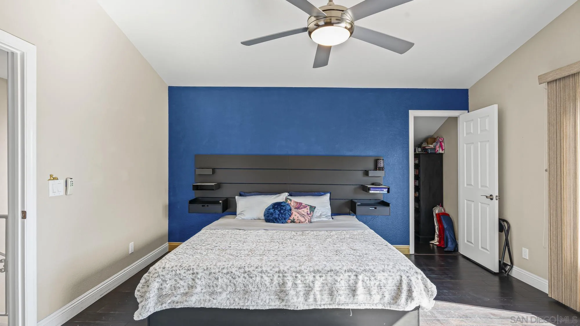 24249 Sargeant Road Ramona, CA 92065 - Photo 18 of 46 a bedroom with a bed and a chandelier