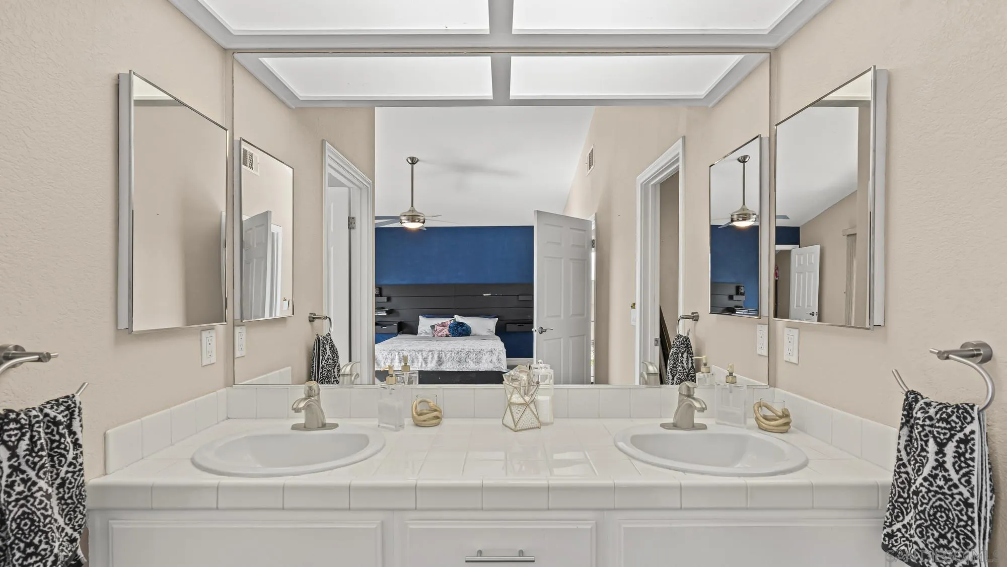 24249 Sargeant Road Ramona, CA 92065 - Photo 21 of 46 a bathroom with double vanity sinks and a mirror