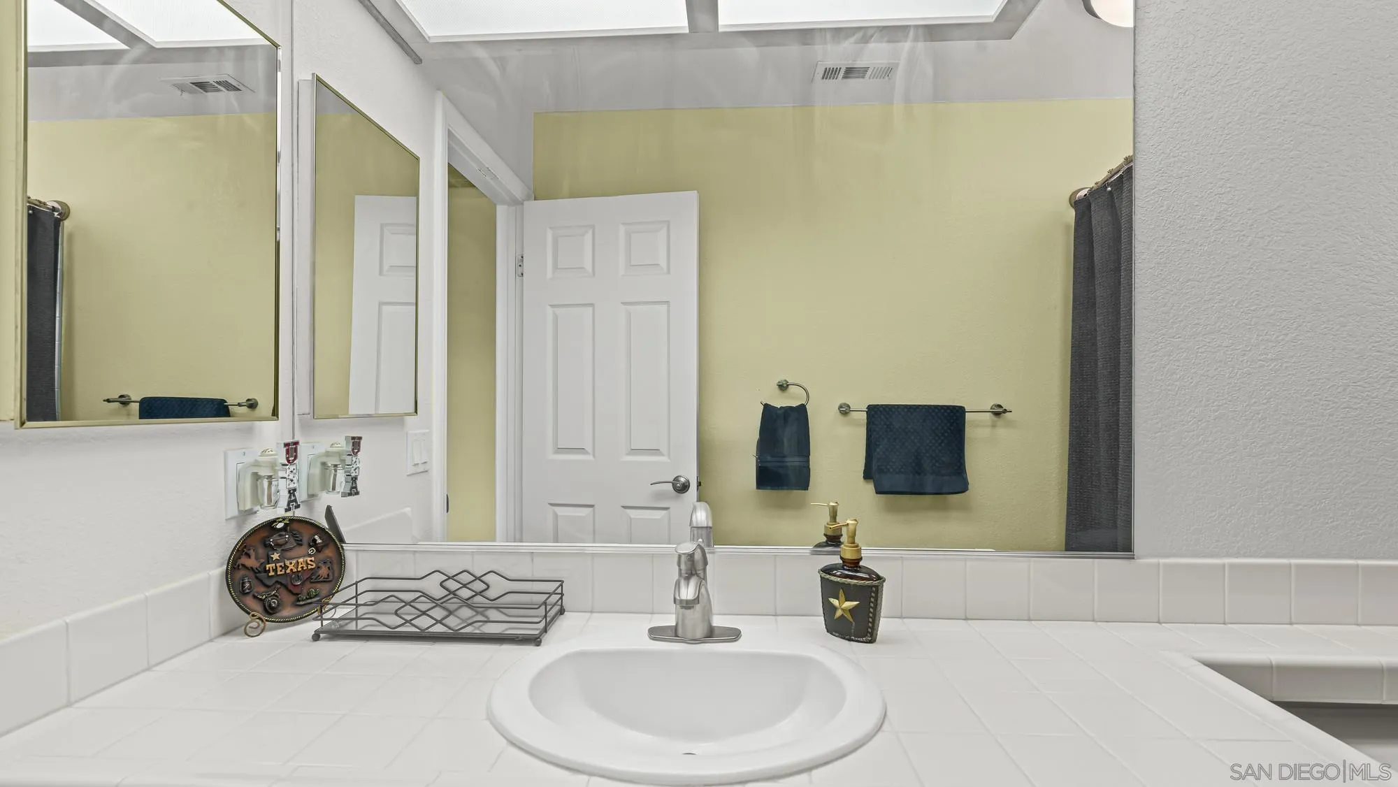 24249 Sargeant Road Ramona, CA 92065 - Photo 24 of 46 a bathroom with a sink and a mirror