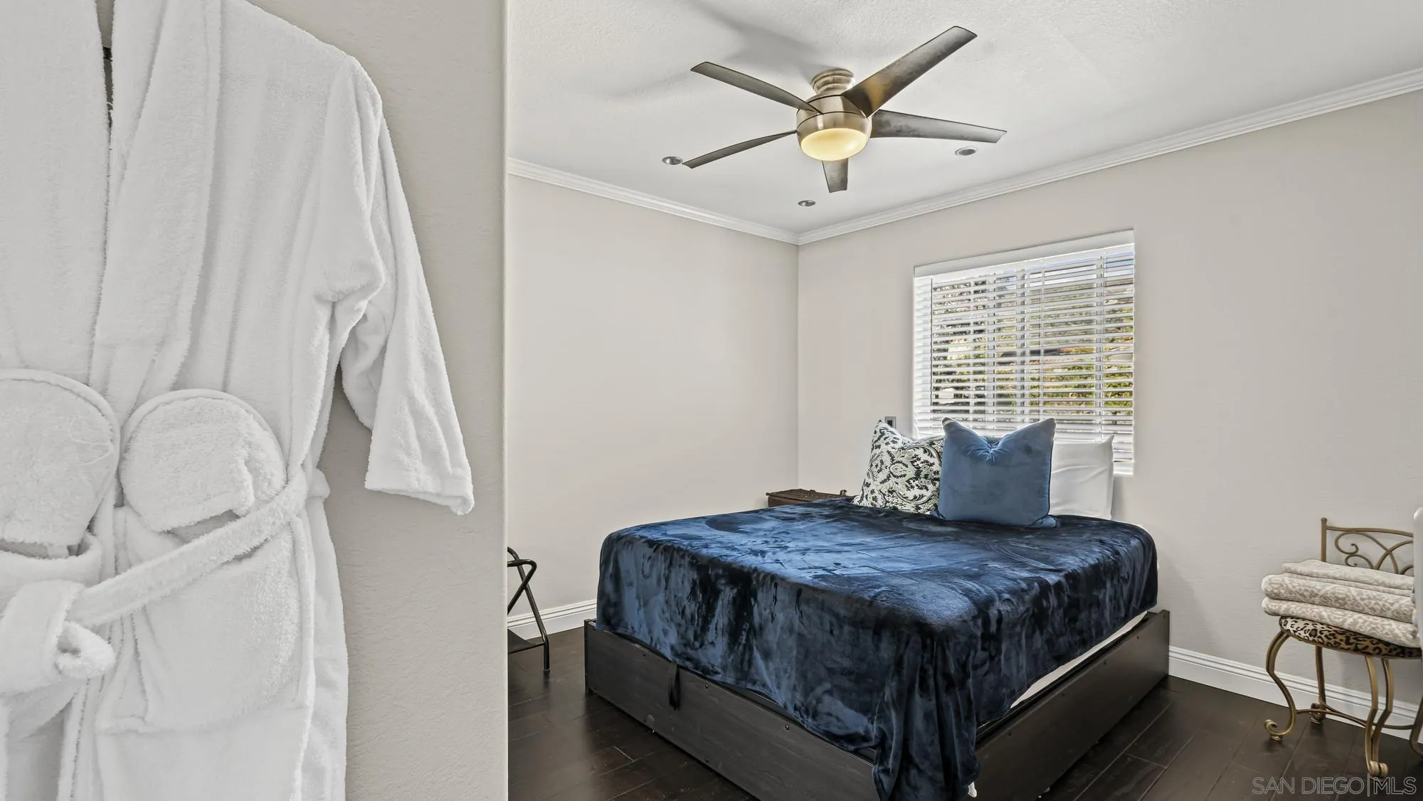 24249 Sargeant Road Ramona, CA 92065 - Photo 25 of 46 a bedroom with a bed next to a window with a chandelier