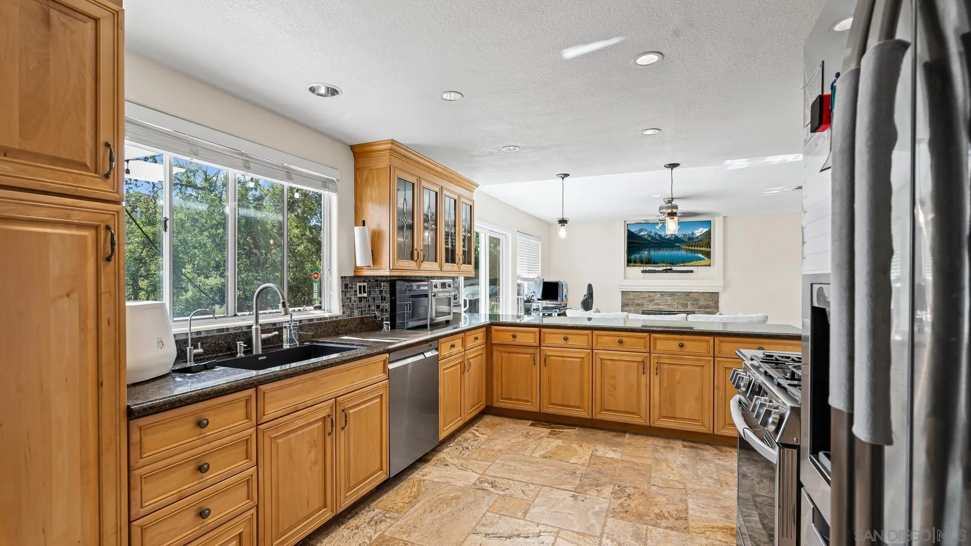 24249 Sargeant Road Ramona, CA 92065 - Photo 7 of 46 a large kitchen with stainless steel appliances granite countertop a sink and cabinets