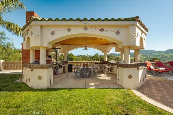 a view of swimming pool with outdoor seating and a yard