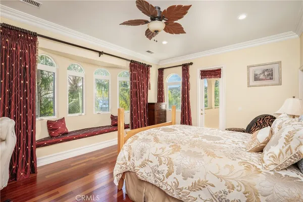 a bedroom with a bed and a large window with the outer view