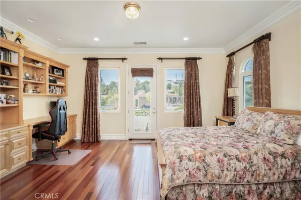 a bedroom with a large bed and a large window