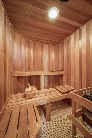 a view of a room with wooden floor and cabinets