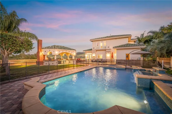 a view of a swimming pool with outdoor seating