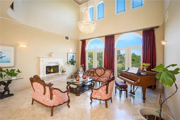 a living room with furniture a fireplace and a potted plant