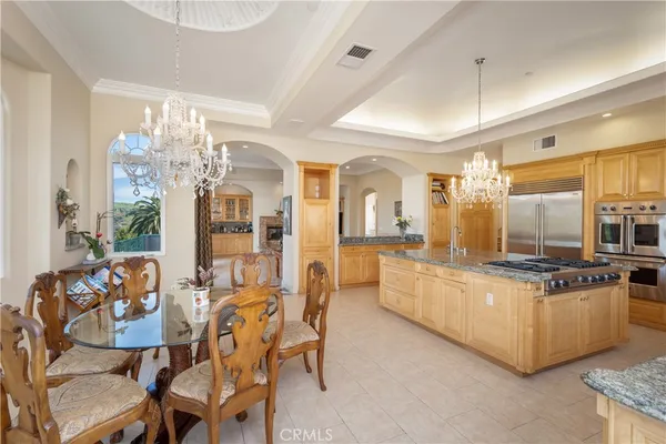 a large kitchen with a table and chairs