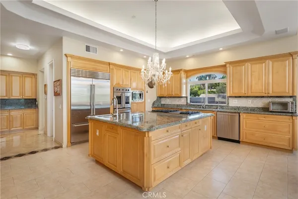 a kitchen with stainless steel appliances granite countertop a stove and a refrigerator