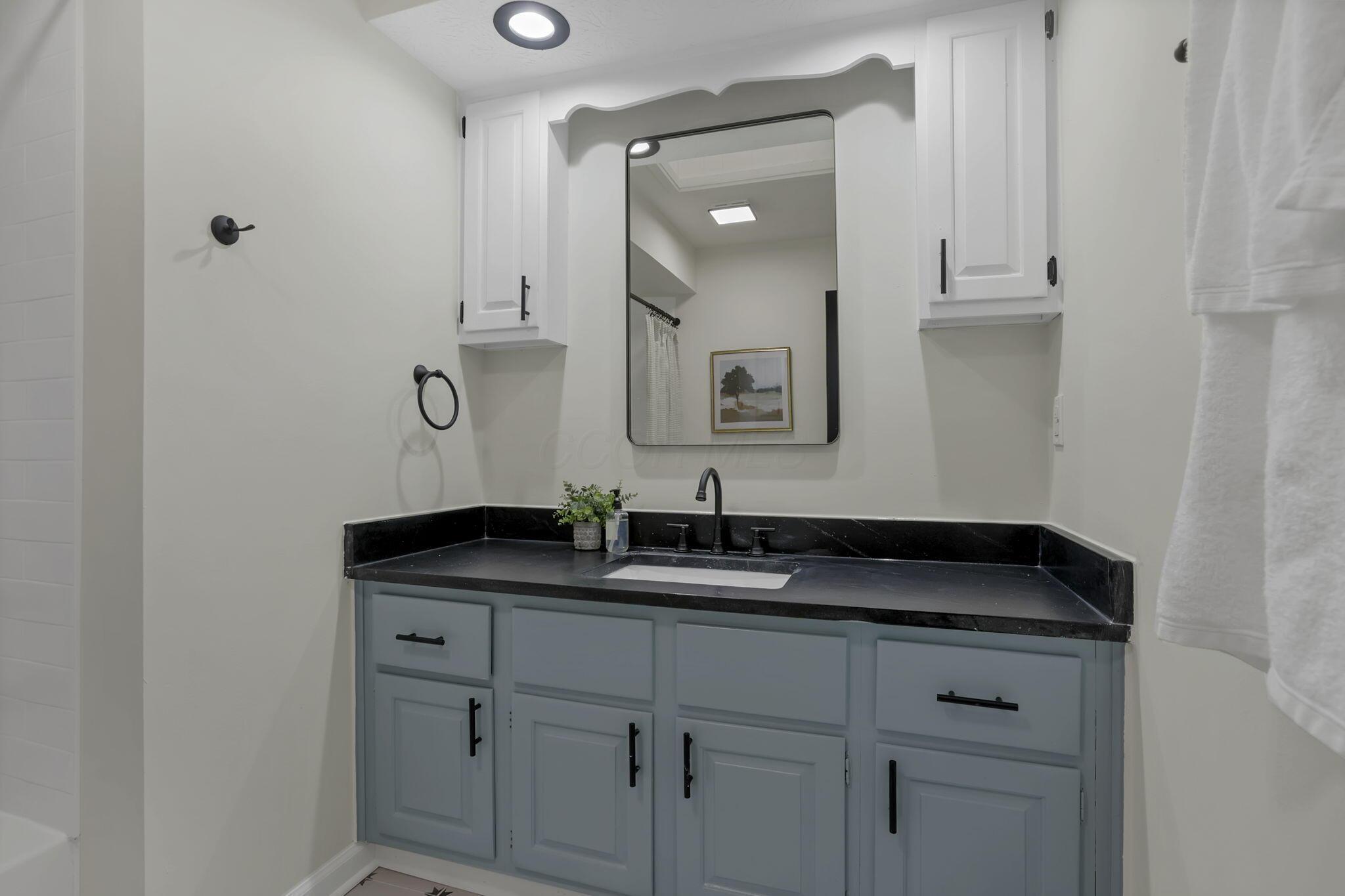 5289 Hazelton-Etna Road Southwest Pataskala, OH 43062 - Photo 33 of 67 Updated vanity, complete with new granite, mirrors, fixtures, and lighting.
