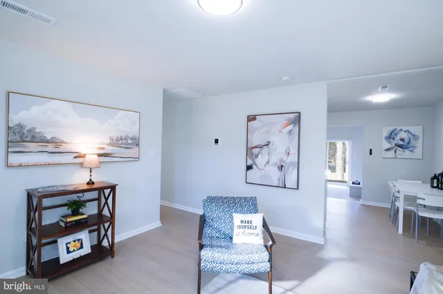 a living room with furniture and a baby crib