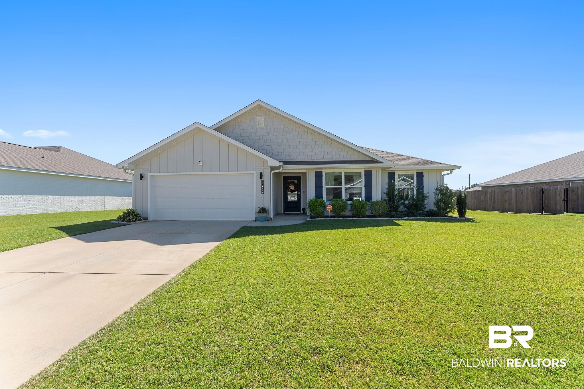24337 Ringneck Loop Elberta, AL 36530 - Photo 1 of 34 Ranch-style home with board and batten siding, concrete driveway, and a garage