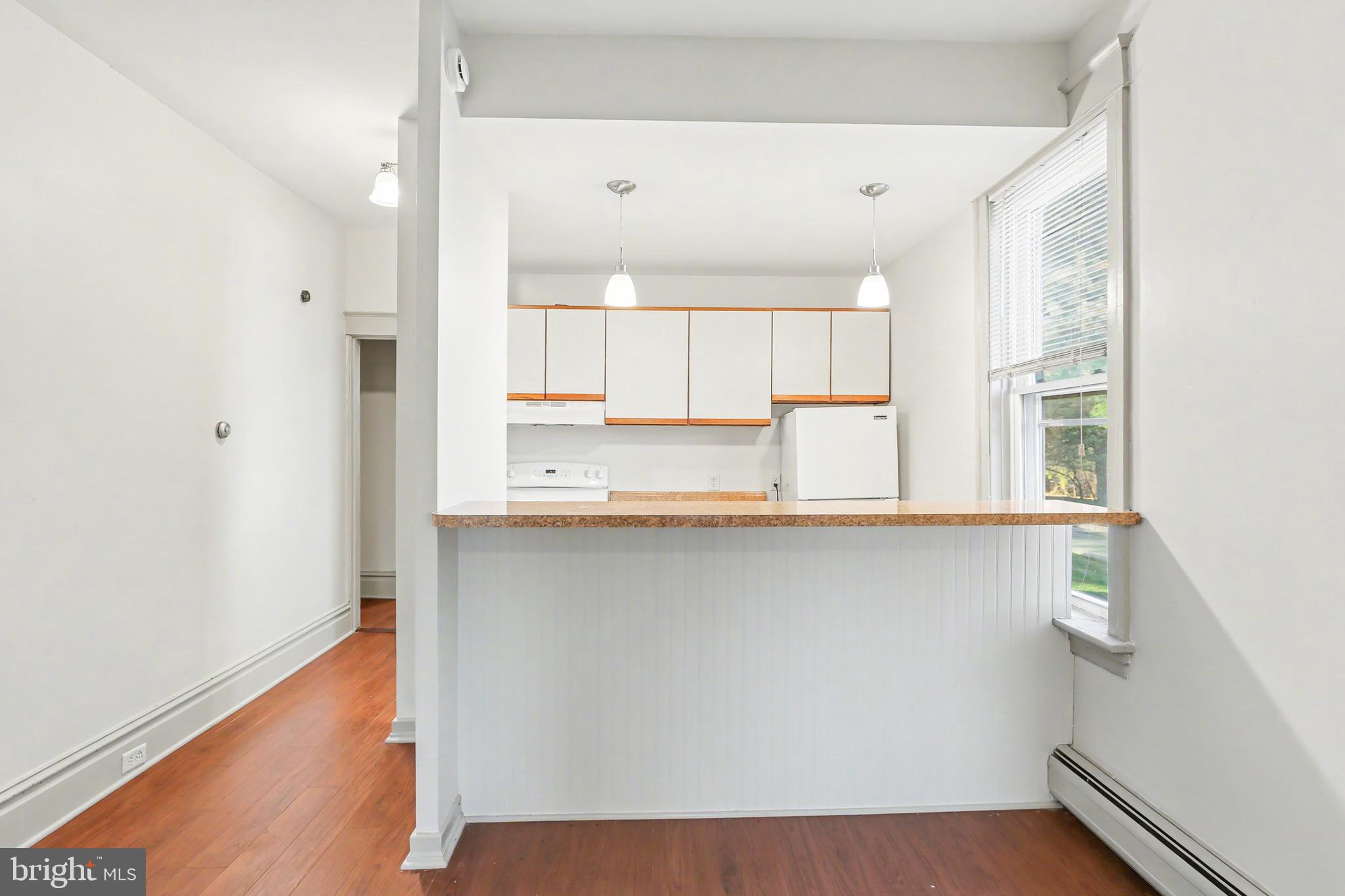 143 15th Street, Unit 1 New Cumberland, PA 17070 - Photo 4 of 10 a kitchen with stainless steel appliances a microwave a sink and a refrigerator