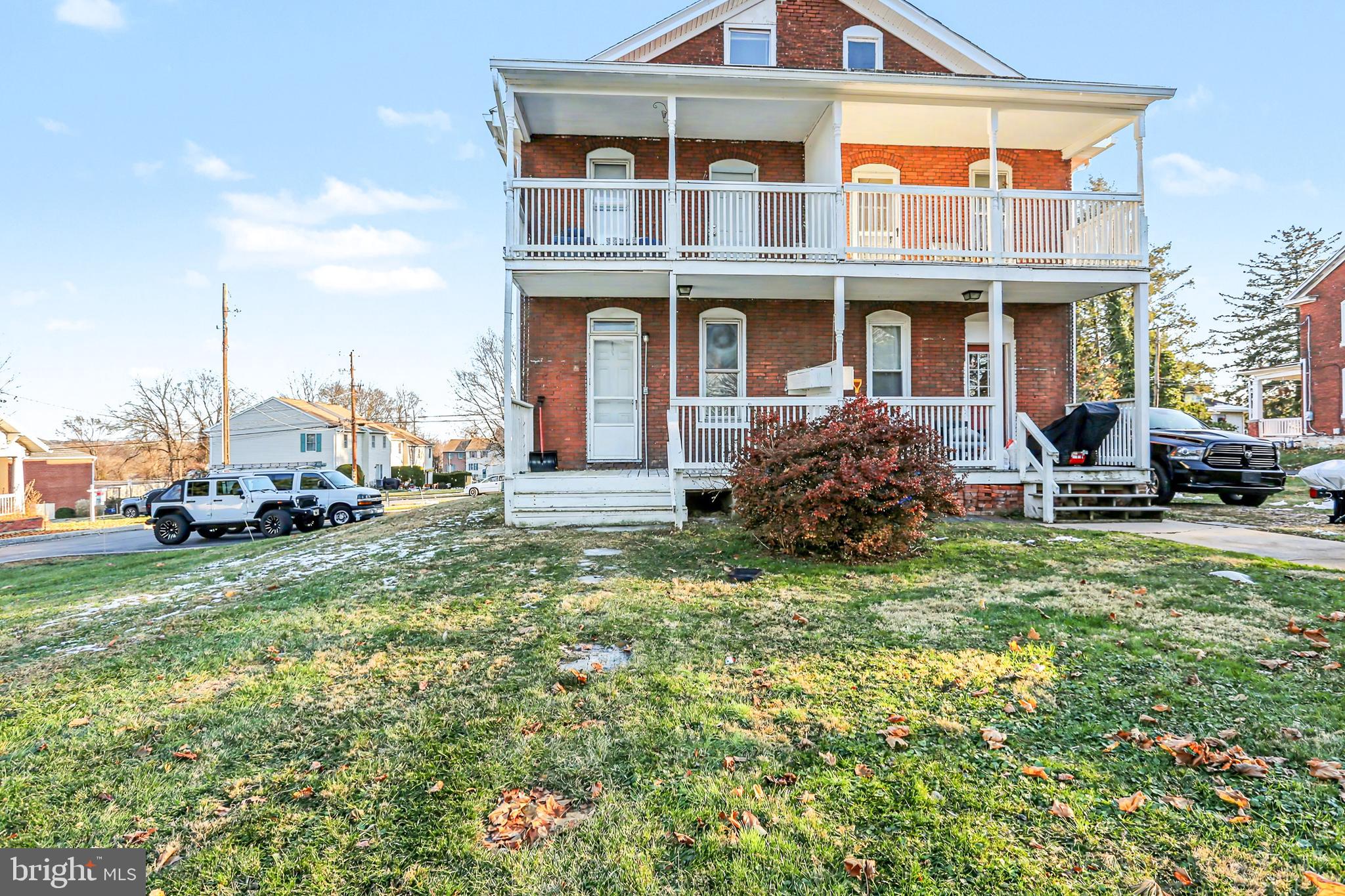 143 15th Street, Unit 1 New Cumberland, PA 17070 - Photo 9 of 10 a view of a house with a yard and lawn chairs
