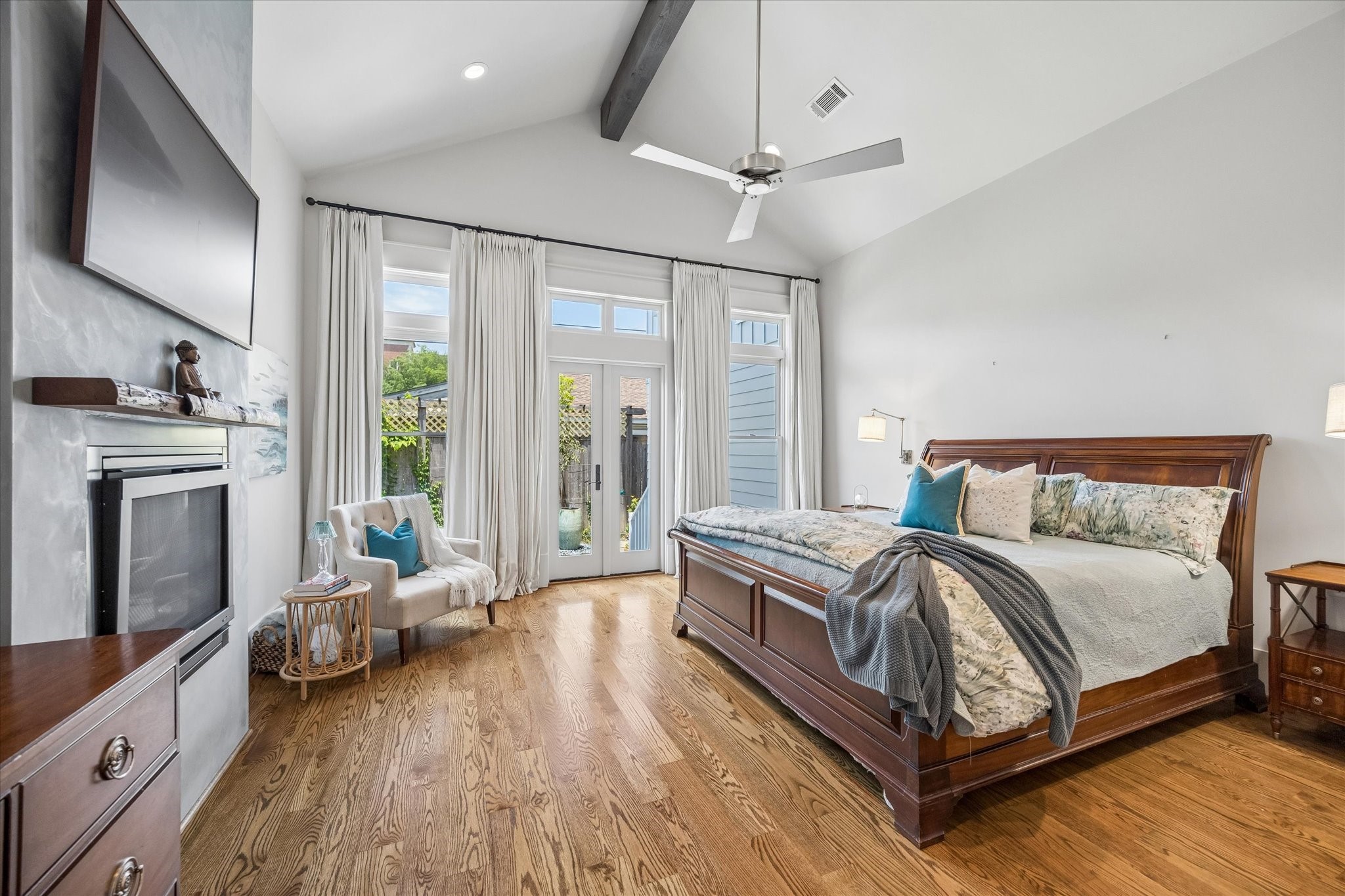 1101 Omar Street Houston, TX 77009 - Photo 19 of 46 Designed for comfort and privacy, the luxurious primary bedroom blends warmth and scale with seamless indoor-outdoor living through private courtyard access just steps from the suite.