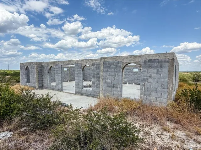 view of a brick house with a yard