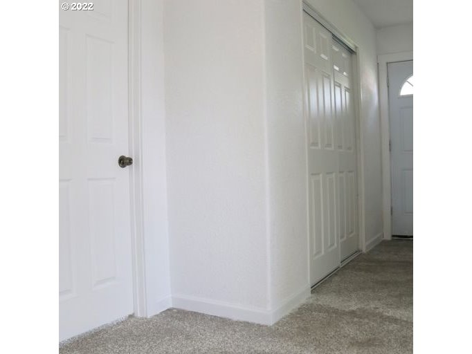 409 West Ridgeway Avenue Hermiston, OR 97838 - Photo 13 of 16 a view of a hallway with wooden floor