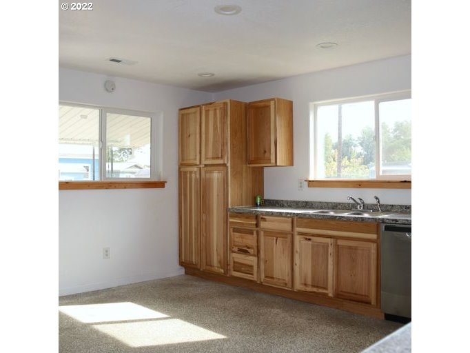 409 West Ridgeway Avenue Hermiston, OR 97838 - Photo 14 of 16 a kitchen with a sink a refrigerator and window