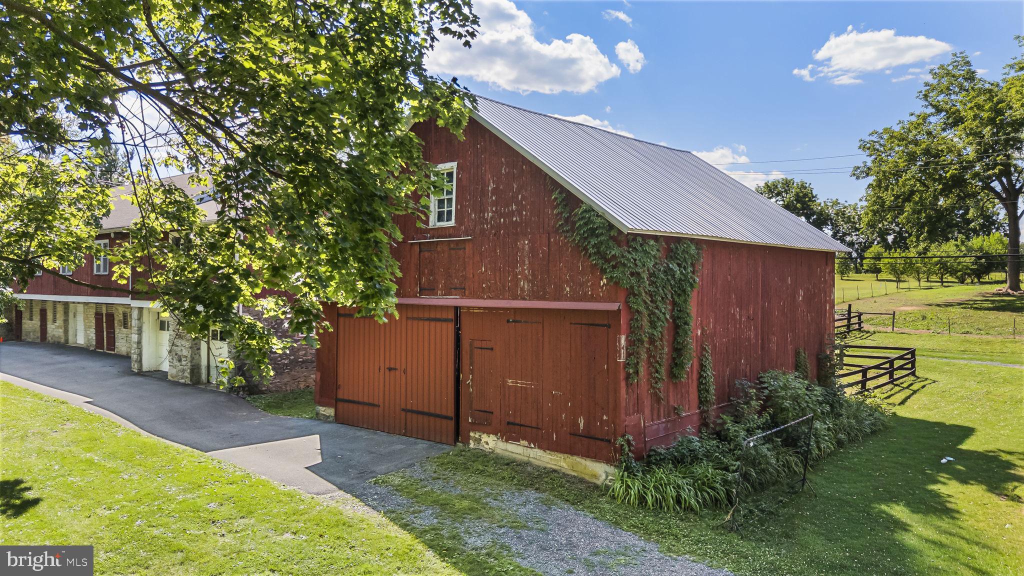 416 Snyder Road Reading, PA 19605 - Photo 58 of 63 Charming red barn amidst lush greenery.