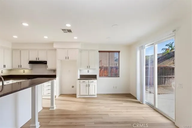 a kitchen with stainless steel appliances granite countertop a refrigerator and a stove top oven