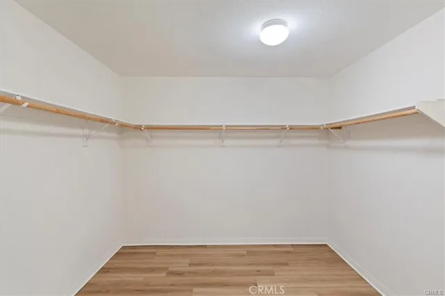 a view of a room with wooden floor and fan