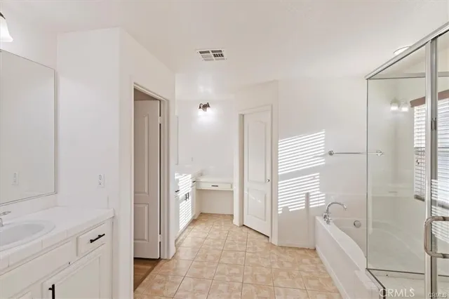 a bathroom with a granite countertop sink a toilet and shower