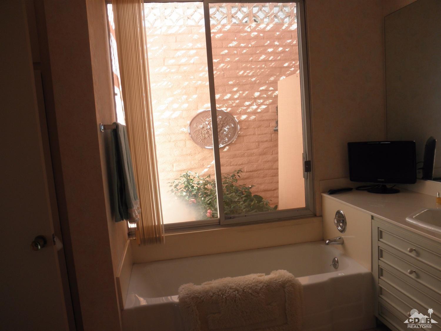 47432 Rabat Drive Palm Desert, CA 92260 - Photo 14 of 21 a bathroom with a bathtub and a window