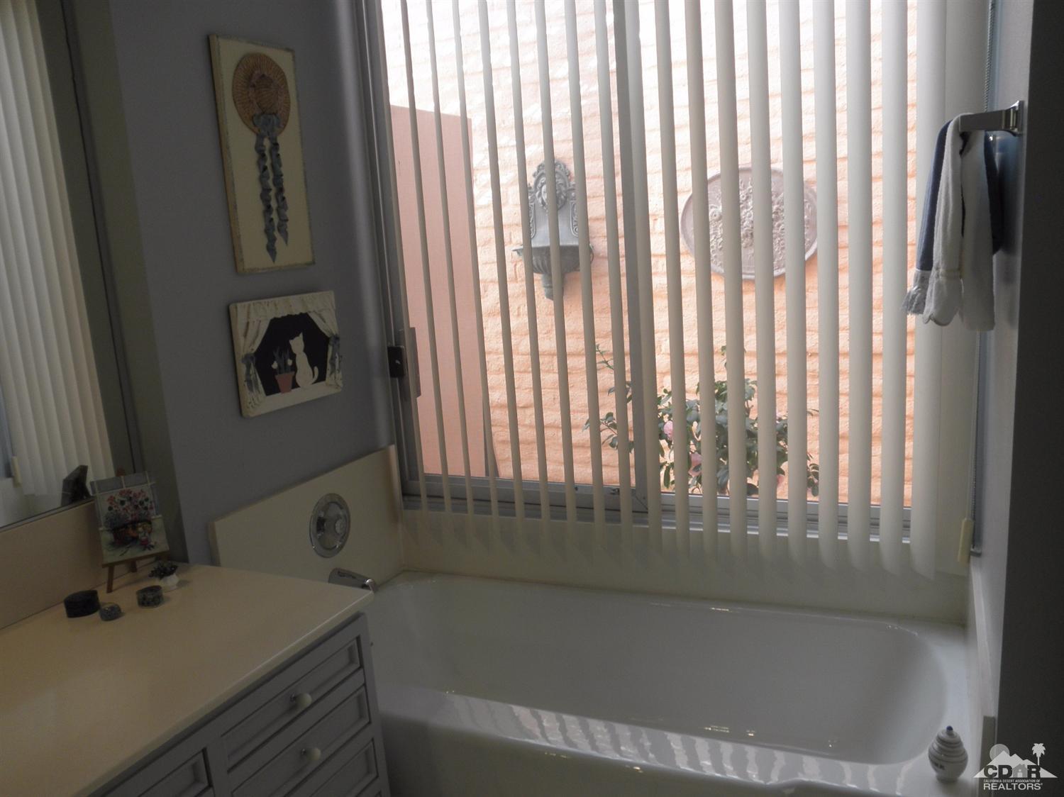 47432 Rabat Drive Palm Desert, CA 92260 - Photo 17 of 21 a bathroom with a bathtub next to a window