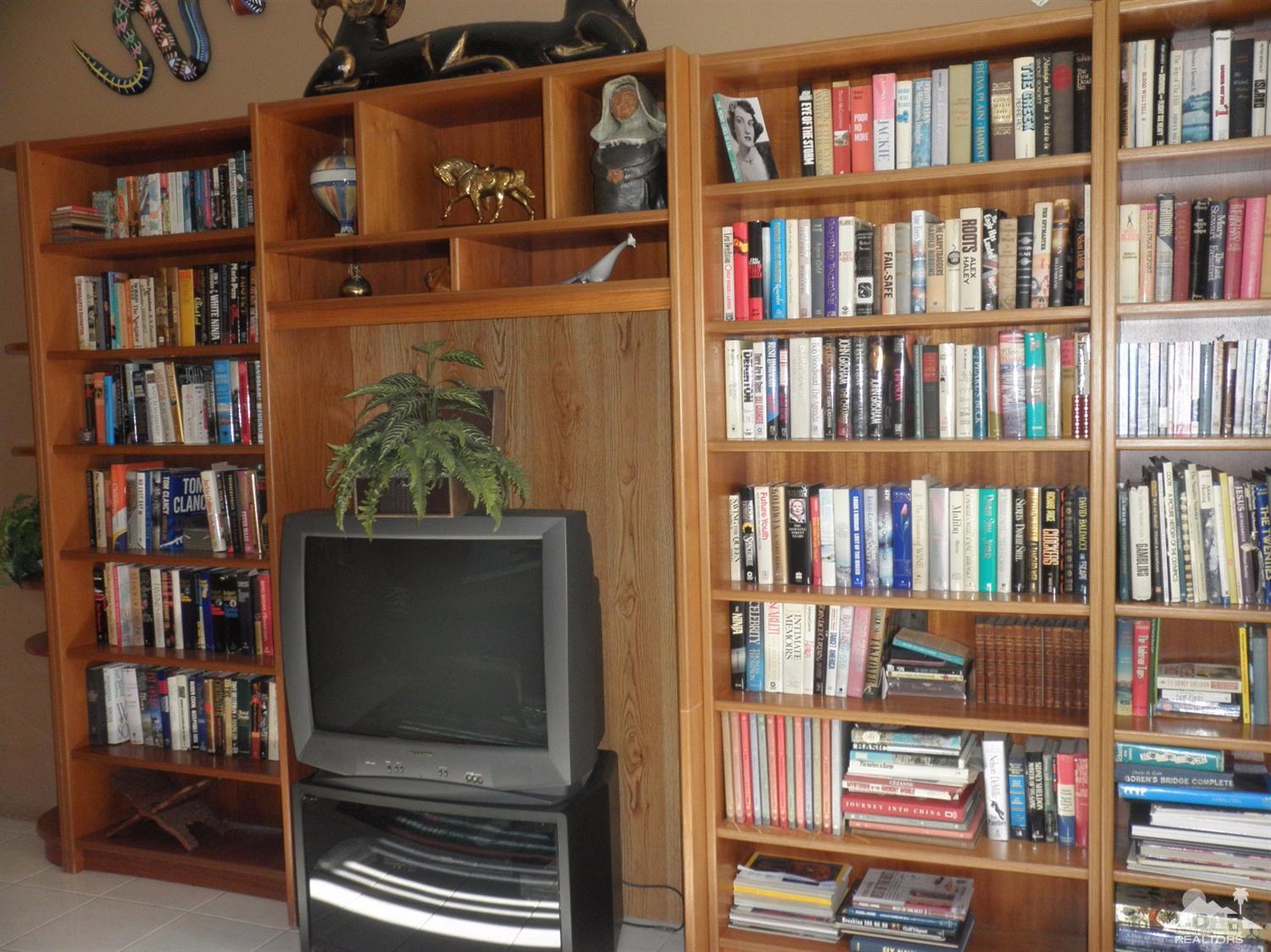 47432 Rabat Drive Palm Desert, CA 92260 - Photo 9 of 21 a bookshelf with wooden floor and book shelf
