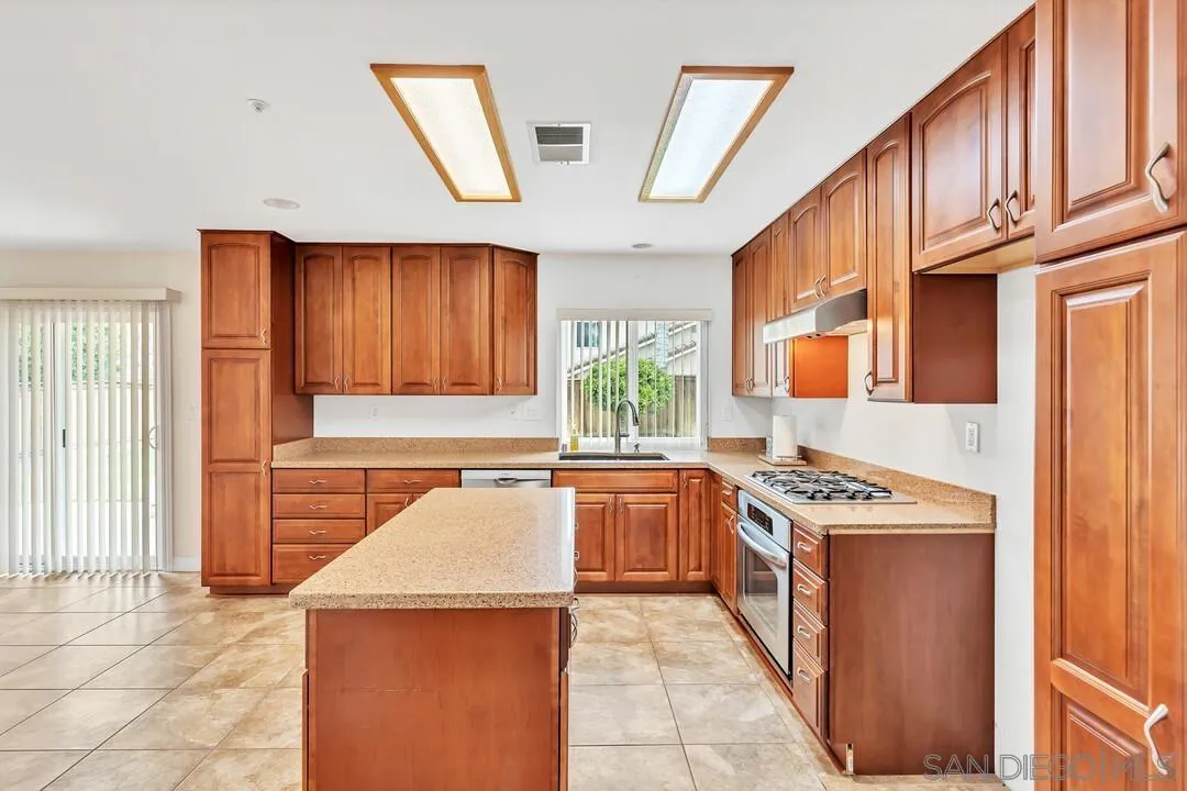 117 Willow Pond Road Santee, CA 92071 - Photo 12 of 49 a kitchen with stainless steel appliances granite countertop a stove a sink and a refrigerator